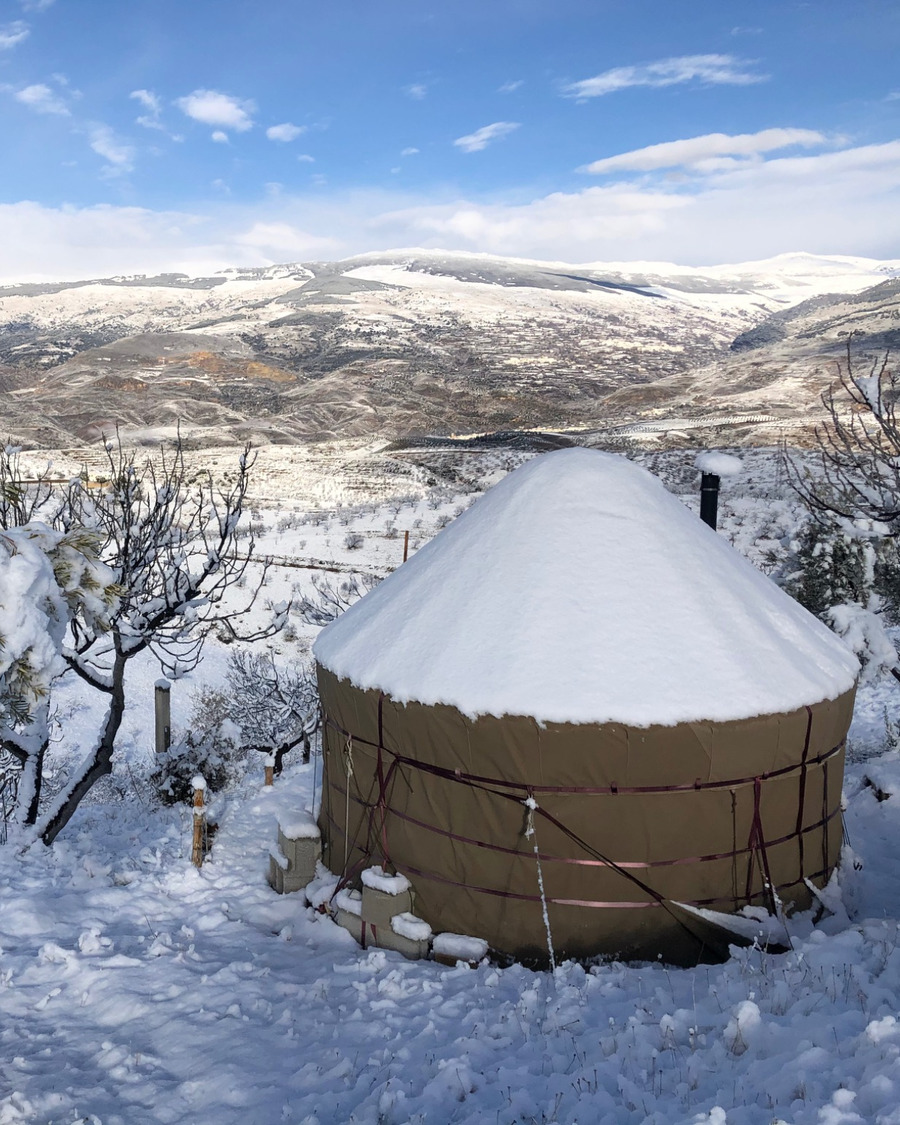 Yurt Workshop yurt in snow with mountain landscape beyond
