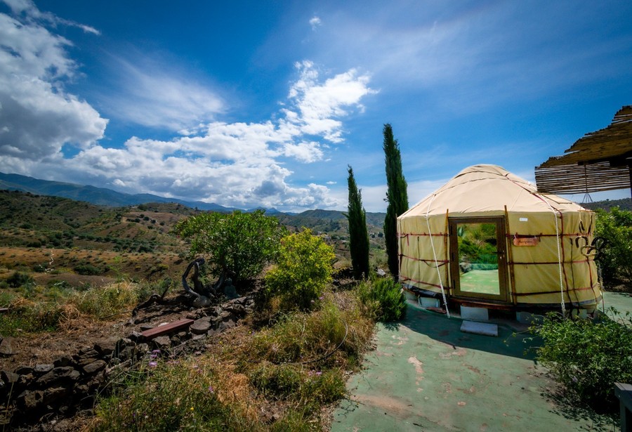 Yurt Workshop yurt with a full-glass door in a mountain landscape